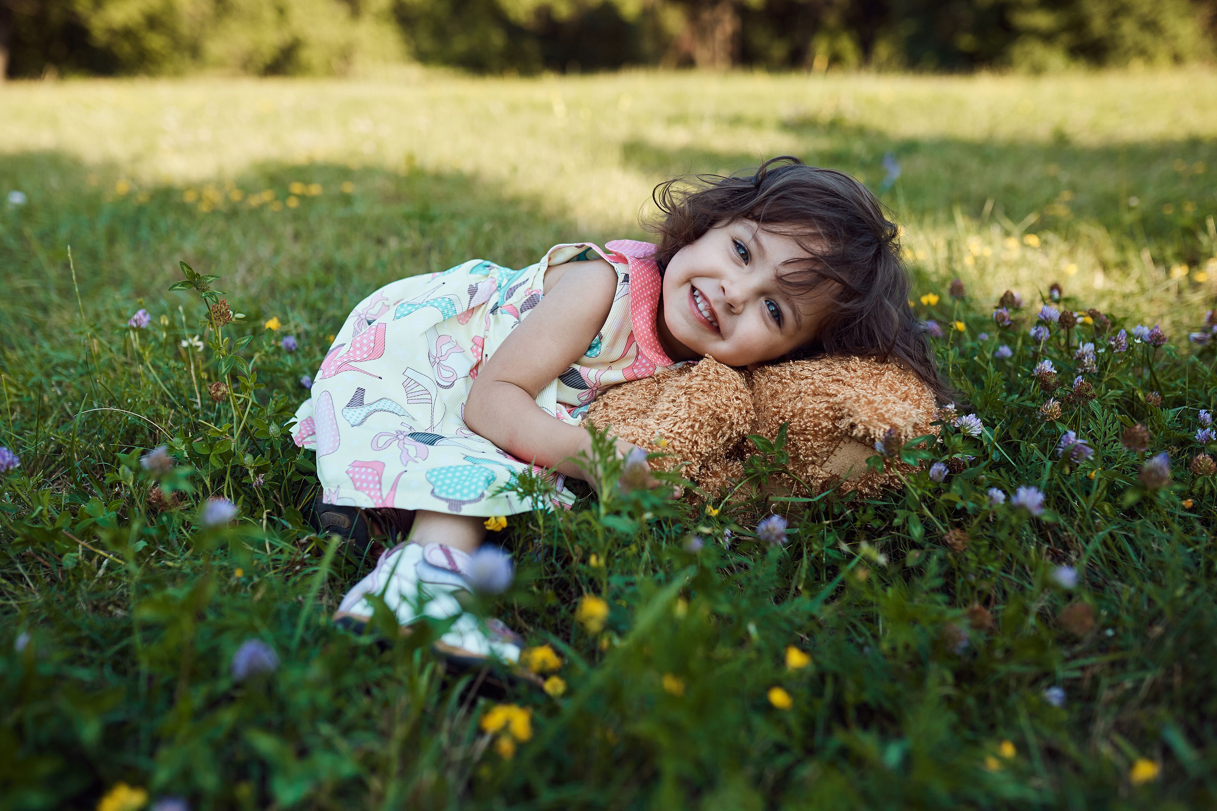 cute-smiling-baby-girl-hugging-soft-bear-toy.jpg
